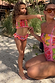 Girls Pink Fruit Crop Bikini Set featuring a shirred bandeau top and frill bottoms for a beach vacation.