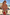 Thumbnail for Fruit Stamps co-ord set featuring tiered frill shorts and bikini top in a Mediterranean fruit print on a sunny beach.