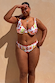 Fruit Stamps bikini bottoms featuring pink whipstitch trim and a Mediterranean fruit print on a curve model.