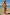 Thumbnail for Fruit Stamps Underwired Bikini Top with a Mediterranean print and pink whipstitch, worn with bikini bottoms on vacation.