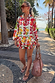 Fruit Stamps Co-ord Set featuring a Mediterranean fruit print shirt and tiered shorts styled on a sunny path.