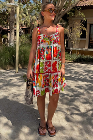 Fruit Stamps Mini Dress with a Mediterranean fruit print, tiered silhouette and red tassel tie detailing.