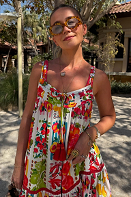 Fruit Stamps Mini Dress with a Mediterranean fruit print and tassel tie detailing, styled for a sunny vacation.