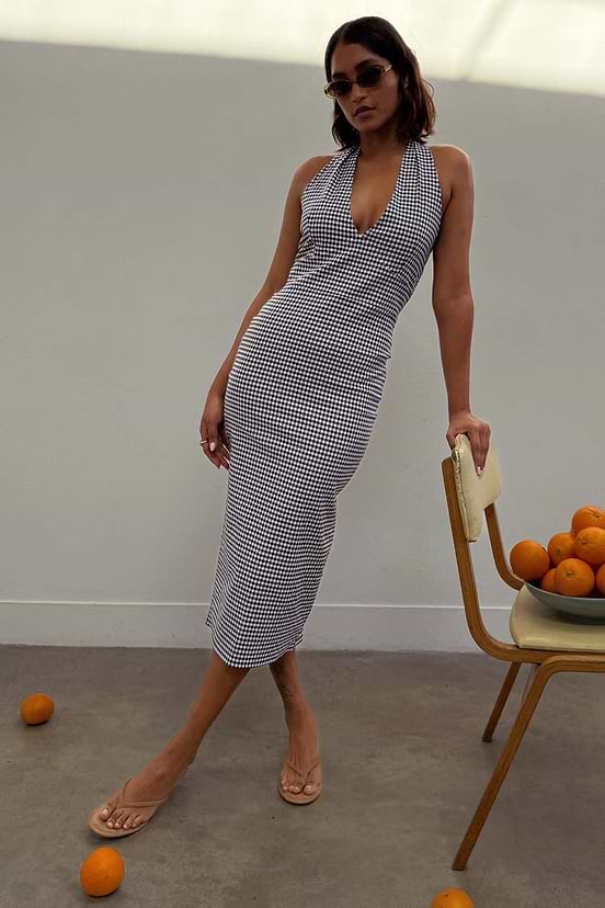Gingham Halterneck Dress in black and white check print, featuring a plunging neckline and fitted midi silhouette.