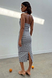 Black and white Gingham Halterneck Midi Dress featuring a back slit, styled with sunglasses and heels.