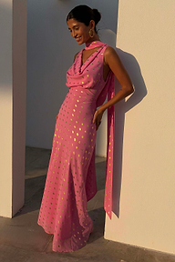 Pink Sophie maxi dress with gold fleck and multi-wear scarf on a model leaning against a white pillar.