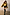 Thumbnail for Gold Fringe Jacket with layered gold foil tassels, styled with black shorts and tall black leather boots.