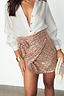 Gold Sequin Mini Jaspre wrap skirt styled with a white button-down shirt and gold cuff.