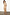 Thumbnail for Gold Plisse Dress with angel sleeves and a pleated texture, shown from the back on a model.