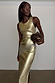 Gold Metallic Ribbed Dress with a sleeveless midi silhouette and side slit, styled with a silver chain belt.