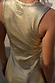 Gold Metallic Ribbed Dress detail featuring shimmering gold textured fabric and a sleeveless back design.