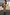 Thumbnail for Gold Metallic Ribbed Midi Dress with a sleeveless silhouette and side slit, shown on a model outdoors.