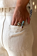 Deloris Silver Circle Ring with textured detailing, styled on a hand in a trouser back pocket.