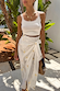 Gold Snake Jaspre Wrap Skirt in white with gold foil motifs, styled with a white top among palm trees.