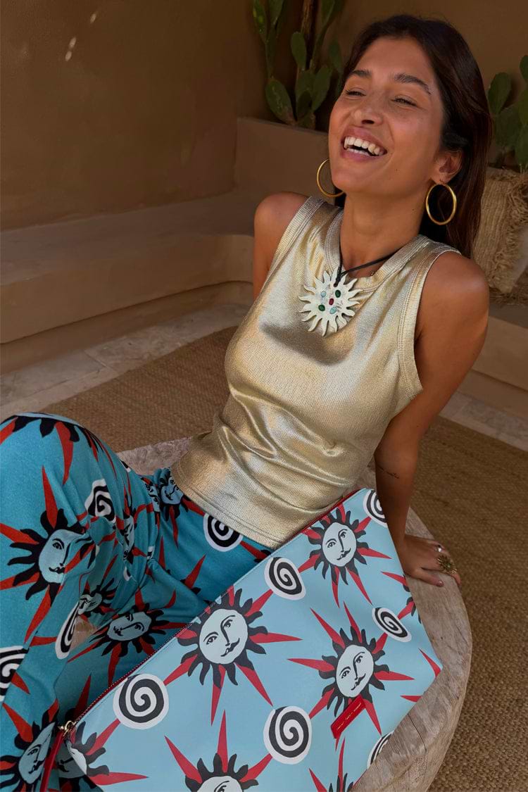 Metallic Gold Ribbed Tank Top paired with sun-print trousers and a clutch for a dopamine dressing summer look.