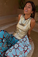 Metallic Gold Ribbed Tank Top paired with sun-print trousers and a clutch for a dopamine dressing summer look.