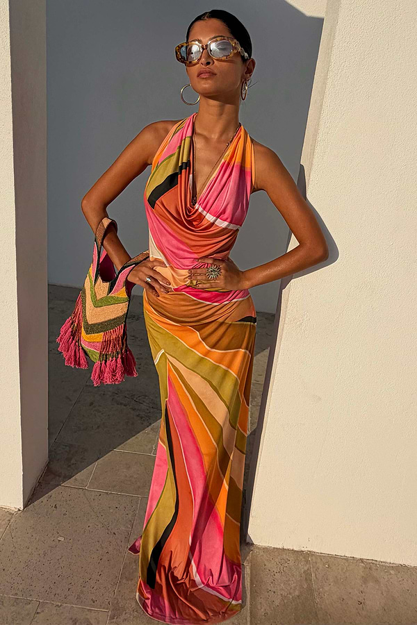 Green Abstract Sabine Maxi Dress in a vibrant multicoloured print with a halter cowl neckline and backless silhouette.