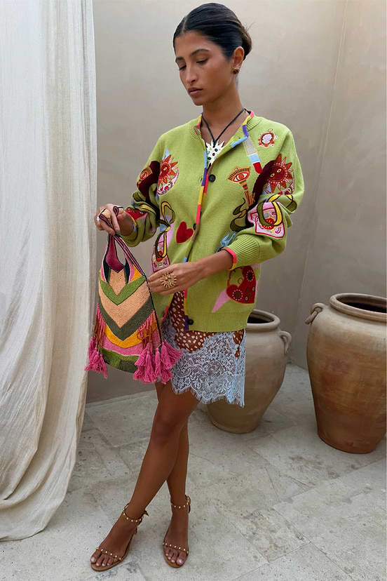 Green Enchanted Cardigan with NFD motifs and a multi-coloured ribbed trim, styled with a lace skirt.