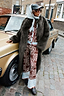 Chocolate Bandana Wide Leg Trousers and matching cardigan paired with a dark green faux fur coat on a London street.