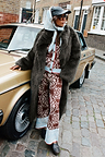 Chocolate Bandana Wide Leg Trousers and matching cardigan paired with a dark green faux fur coat on a London street.