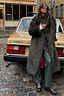 Green Faux Fur Coat featuring a relaxed silhouette and pink lining, styled against a vintage car.