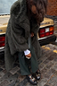 Thumbnail for Green Faux Fur Coat in a relaxed silhouette, styled as a statement staple for a London street look.