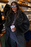 Thumbnail for Green Faux Fur Coat with a shaggy texture and relaxed silhouette, styled with sparkly sunglasses in a cafe.