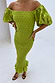 Thumbnail for Olive Jojo Dress with Gold Fleck, shirred body and puff sleeves, worn off-the-shoulder by a 5ft5 model in UK size XS.