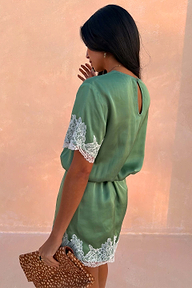 Green Lace Mini Dress with cream lace trims and a keyhole back detail, styled with a leopard print clutch.