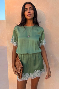 Green Lace Mini Dress with cream lace trims, an elasticated waist and shift silhouette, styled with a leopard print clutch.