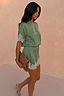 Green Lace Mini Dress featuring contrast cream lace trims and a shift silhouette, styled with a leopard print clutch.
