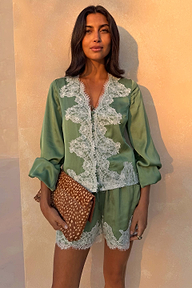 Green satin Maeva Shorts with white lace edging, styled as a co-ord for an elevated London look.