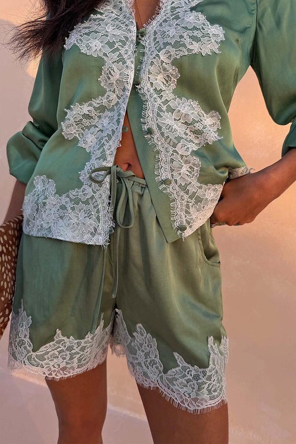 Green Lace Maeva Shorts in satin with white lace edging and a functional drawstring waist.
