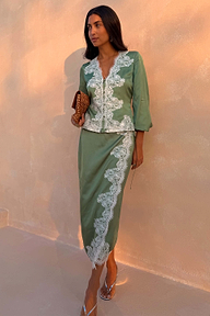 Green Lace Wrap Midi Skirt with cascading white lace and tie waist, styled with a matching top on a model.
