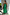 Thumbnail for Green Lola Mid-axi Dress with a ruched strapless bodice and flowing cotton skirt, styled for a summer vacation.