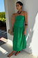 Green Lola Mid-axi Dress with a ruched strapless bodice and flowing cotton skirt, styled for a summer vacation.