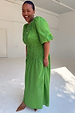 Green Shirred Nara Dress featuring a smocked bodice and puff sleeves, highlighting inclusive sizing on a smiling model.
