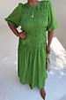 Green Shirred Nara Dress featuring a smocked bodice and puff sleeves, shown on a model for inclusive sizing.