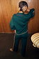 Bottle Green Safari Cardigan featuring fringe detailing and matching knit trousers with orange whipstitch trim.