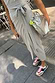 Thumbnail for Grey Jesse Jersey Wrap Dress with a front tie-waist in soft marl, styled with a silver bag and trainers.