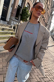 Grey Check Blazer layered over a grey sweatshirt and lace-trimmed denim for a London look.