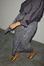 Gunmetal Sequin Jaspre Midi Skirt in a wrap style, paired with a grey blouse and gold mules.