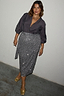 Thumbnail for Model wears the iconic Gunmetal Sequin Jaspre wrap midi skirt with a grey shirt and gold mules.