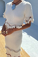 Ivory and Red Harper Dress featuring cream crochet knit, tassel details, and red bead accents.