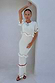 Thumbnail for Ivory and Red Harper Dress, a cream knit midaxi with crochet scallop trim and white tassels, styled in a white archway.
