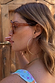 Hexagon Orange Sunglasses with light-tinted lenses and side-arm branding, worn by a model in a side profile.