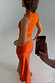 Hot Coral Ribbed Tank in orange ribbed fabric, shown from the back during a behind-the-scenes photoshoot.
