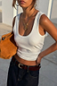 Thumbnail for Deloris I Love You Lariat Necklace in chunky brass with a spinning pendant, styled on a model wearing a white tank top.