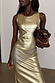 Deloris Thin Chain I Love You Necklace with a spinning brass pendant, designed in London and styled with a gold dress.