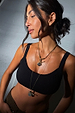 Deloris Thin Chain I Love You Necklace in brass featuring a spinning engraved pendant and lariat drop detail.